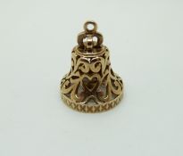 A 9ct gold charm in the form of a bell,