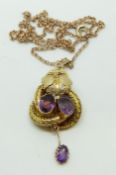 A Victorian pendant set with two oval amethysts with textured foliate design and another drop