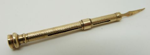 A yellow metal propelling toothpick se with agate to the end