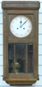 A c1910 oak cased two train wall clock striking on a gong