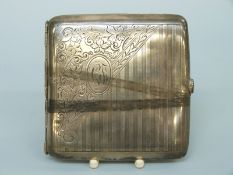 A white metal spring loaded cigarette case marked sterling silver,