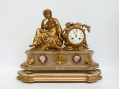 A 19thC ormolu and marble mantel clock with seated Romanesque female figure to one side, and lyre,