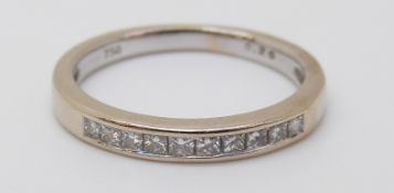 An 18ct white gold half eternity ring set with square cut diamonds totalling approximately 0.2ct, 2.