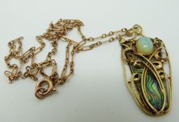 An Art Nouveau yellow metal necklace set with a piece of abalone to the ground and an opal cabochon