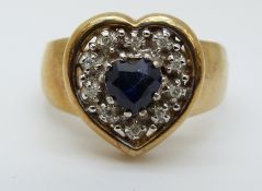 An 9ct gold ring set with a heart shaped sapphire surrounded by diamonds (size M)