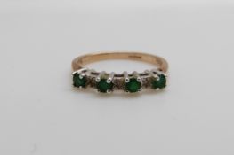 A 9ct gold ring set with emeralds and diamonds (size L)