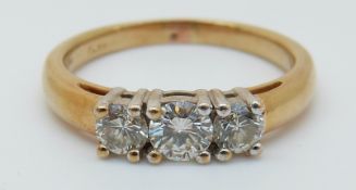 An 18ct gold ring set with three diamonds, total 0.