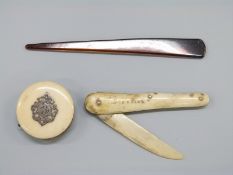 An ivory and white metal pin cushion,