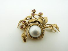 A Givenchy 14k gold brooch set with a central mabe pearl with a crescent of diamonds,