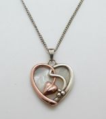 A 9ct gold and silver Clogau pendant in the shape of a heart set with mother of pearl