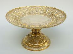 A Victorian silver gilt hallmarked silver tazza with embossed floral and fruit decoration,