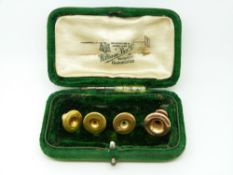 A set of three 9ct gold studs (2.55g) and a 15ct gold stud (0.