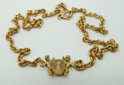 A 9ct gold necklace set with a crystal sphere and two cherubs signed to the back