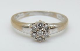 An 18ct white gold ring set with diamonds in a cluster, 2.