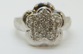 A 14ct white gold ring set with diamonds in a cluster,