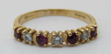 An 18ct gold ring set with alternating diamonds and rubies (size L)