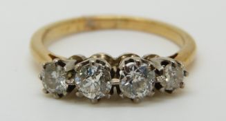 An 18ct gold ring set with four diamonds, total diamond weight approximately 0.