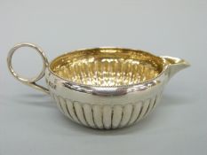 A small Victorian Mappin & Webb hallmarked silver cream jug, Sheffield 1898, length 10.