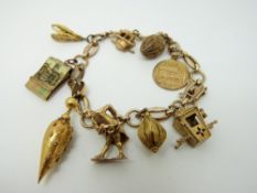 A 9ct gold charm bracelet with 9 charms including a two Victorian charms,