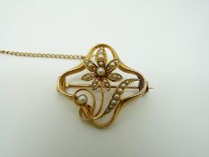 A 15ct gold Edwardian brooch set with seed pearls in a floral Art Nouveau design, 2.