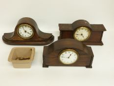 Three c1920's mantel clocks in oak cases, two with barley twist style decoration,