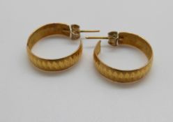 A pair of yellow metal hoop earrings, 3.