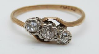 A 9ct gold ring set with three diamonds in a platinum twist setting, 2.