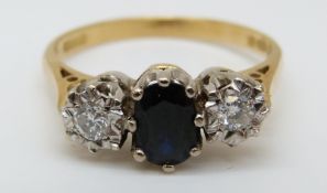 An 18ct gold ring set with a sapphire of approximately 0.5ct and two diamonds totalling 0.