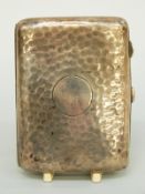 A hallmarked silver cigarette case with hammered decoration, Chester 1918,