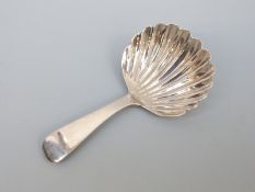 A George III hallmarked silver tea caddy spoon of shell form London 1815,