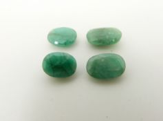 Four oval cut emeralds the largest approximately 1.