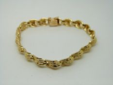 A 14ct gold bracelet with textured decoration, 13.