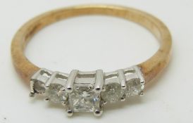 An 18ct gold ring set with five princess cut diamonds, 1.