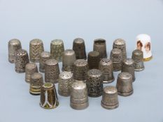 A collection of hallmarked silver and other thimbles comprising 11 hallmarked silver examples
