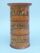 A turned treen three tier spice container labelled Cloves, Nutmeg and Cinnamon,