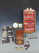 A collection of teaspoons in display stand, smoker's knives, gents wash set,