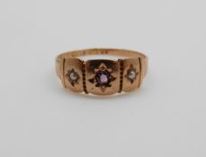 A Victorian 15ct gold ring set with an amethyst and seed pearls, 1.