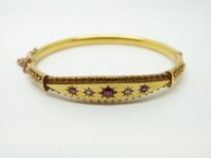 A 15ct gold bangle set with garnets and seed pearls, Chester 1906, 9.
