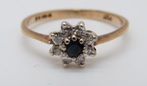 A 9ct gold rings set with a sapphire surrounded by diamonds in a cluster (size I)