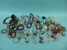 A large quantity of costume jewellery including beads,