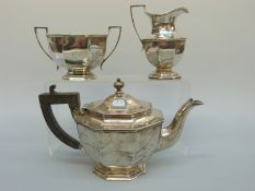 A George V hallmarked silver octagonal three piece teaset, London 1910 maker Thomas Bradbury & Sons,