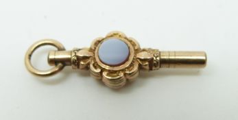 A Victorian pocket watch key set with agate cabochons