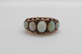A 9ct gold ring set with five graduated opal cabochons and diamonds,