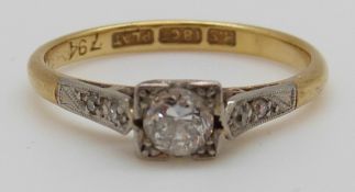 An 18ct gold ring set with a diamond of approximately 0.