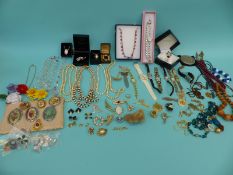 A collection of jewellery to include glass beads, pearls, cameos, silver ingot, silver necklaces,