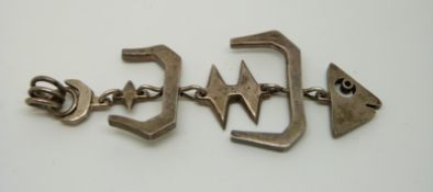 A 1950s Mexican silver pendant in the form of a stylised fish skeleton.