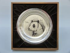 A white metal shallow plate decorated with a panda by Bernard Buffet,