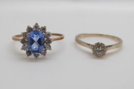 A 9ct gold ring set with a cubic zirconia and a 9ct gold ring set with an oval blue topaz