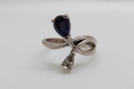 An 18ct white gold ring set with a pear cut tanzanite and a pear cut diamond (size I)
