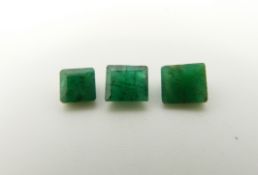 An emerald cut emerald of approximately 0.5ct and two square cut emeralds approximately 0.